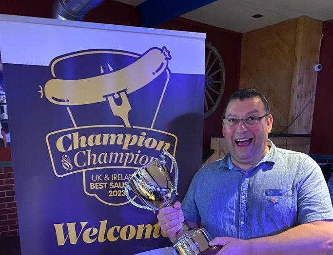 Dales' Mark Duckworth hands firmly fixed on his Champion of Champions 2023 Sausage Award Trophy